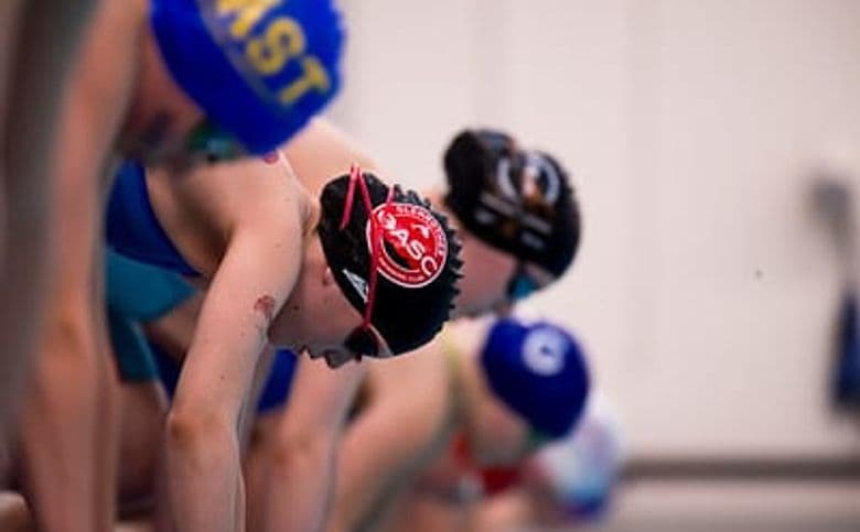 Swimmers lined up on the starting blocks