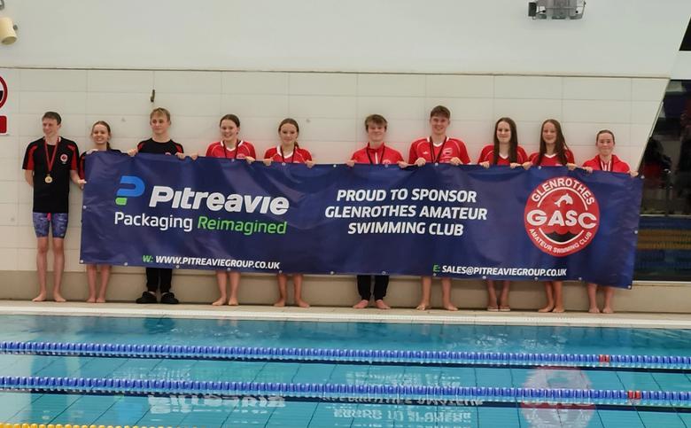 Winners holding a banner