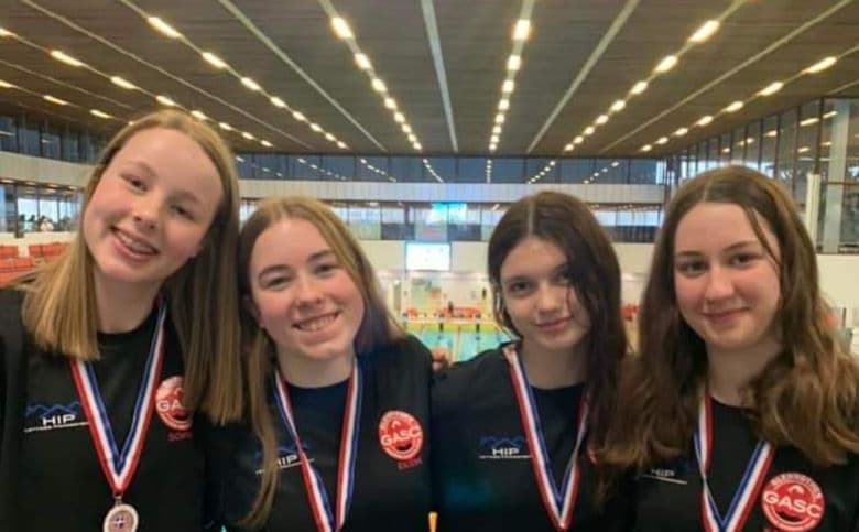 A group of swimmers with their medals after the East District Age Group Championships