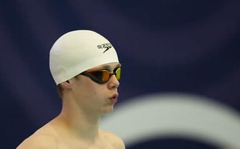 A swimmer lining up to start the race.