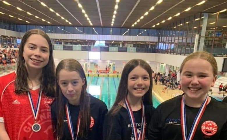 A group of swimmers with their medals after the East District Age Group Championships